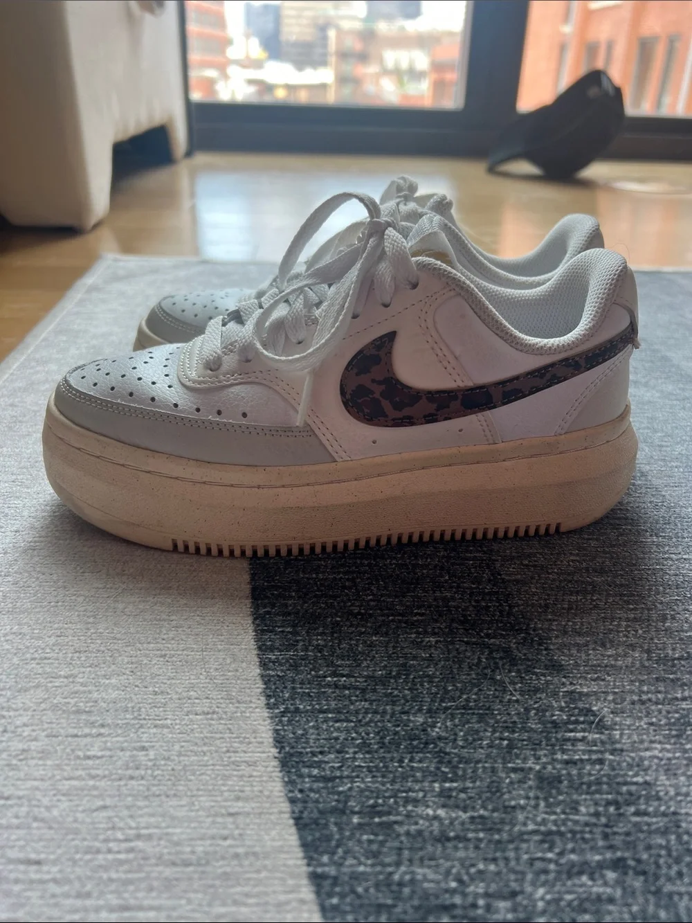 Nike sneakers with leopard print swoosh